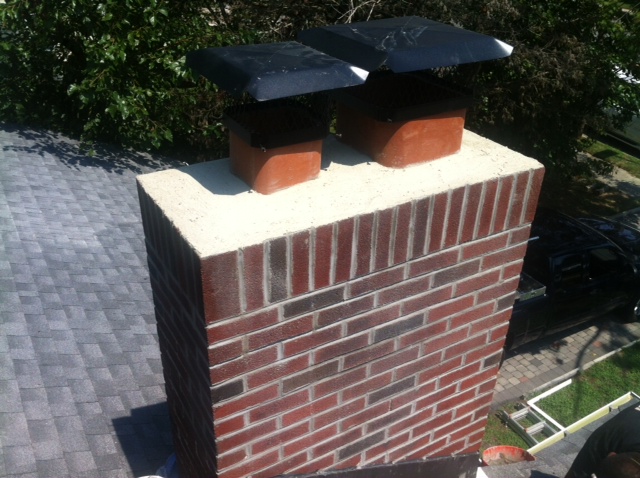 A closeup of a chimney stack on a house.