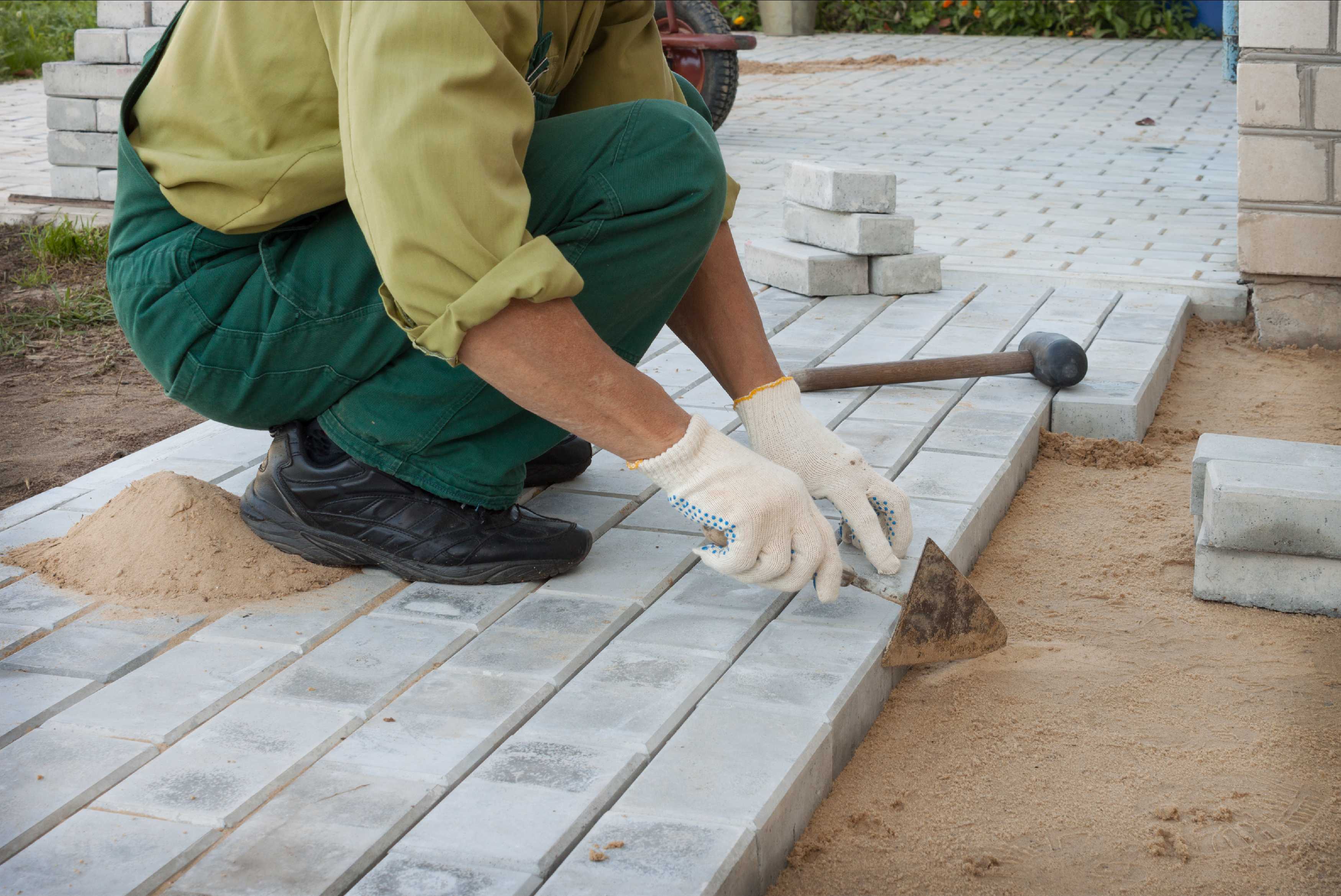 A man laying gray bricks.