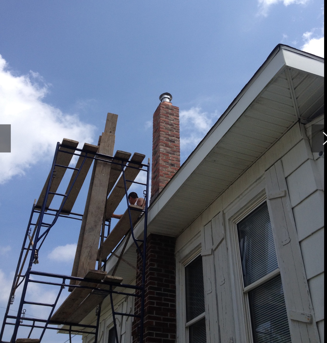 Scaffolding installed outside a home for a chimney service.