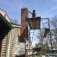 A team performing chimney pointing.