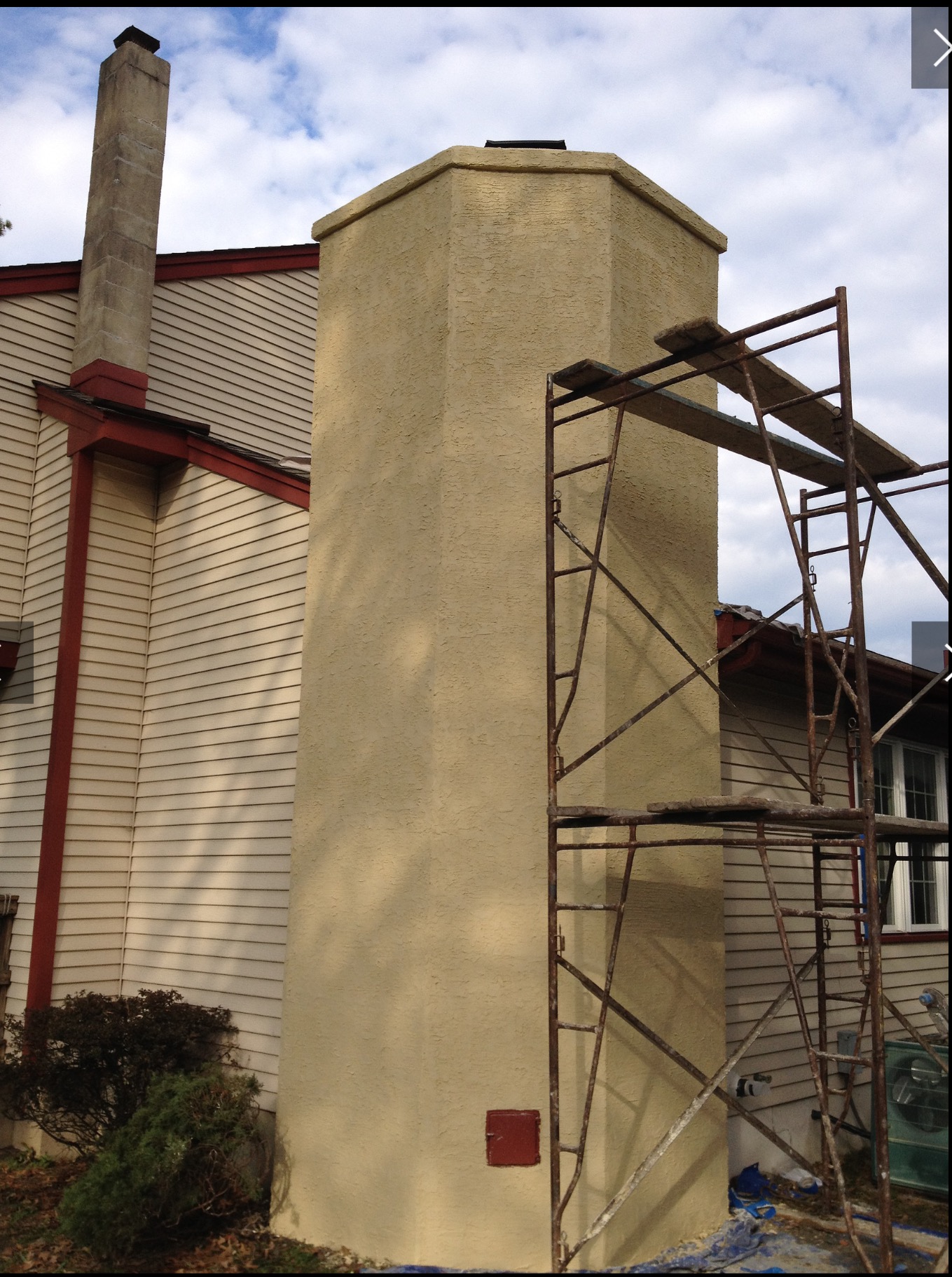 Scaffolding outside a home for a chimney service.