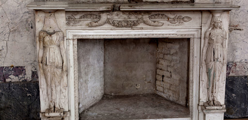 An old, empty fireplace.