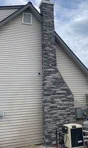 A stone chimney attached to a residential home in NJ.