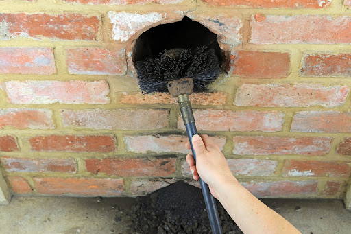 person cleaning chimney